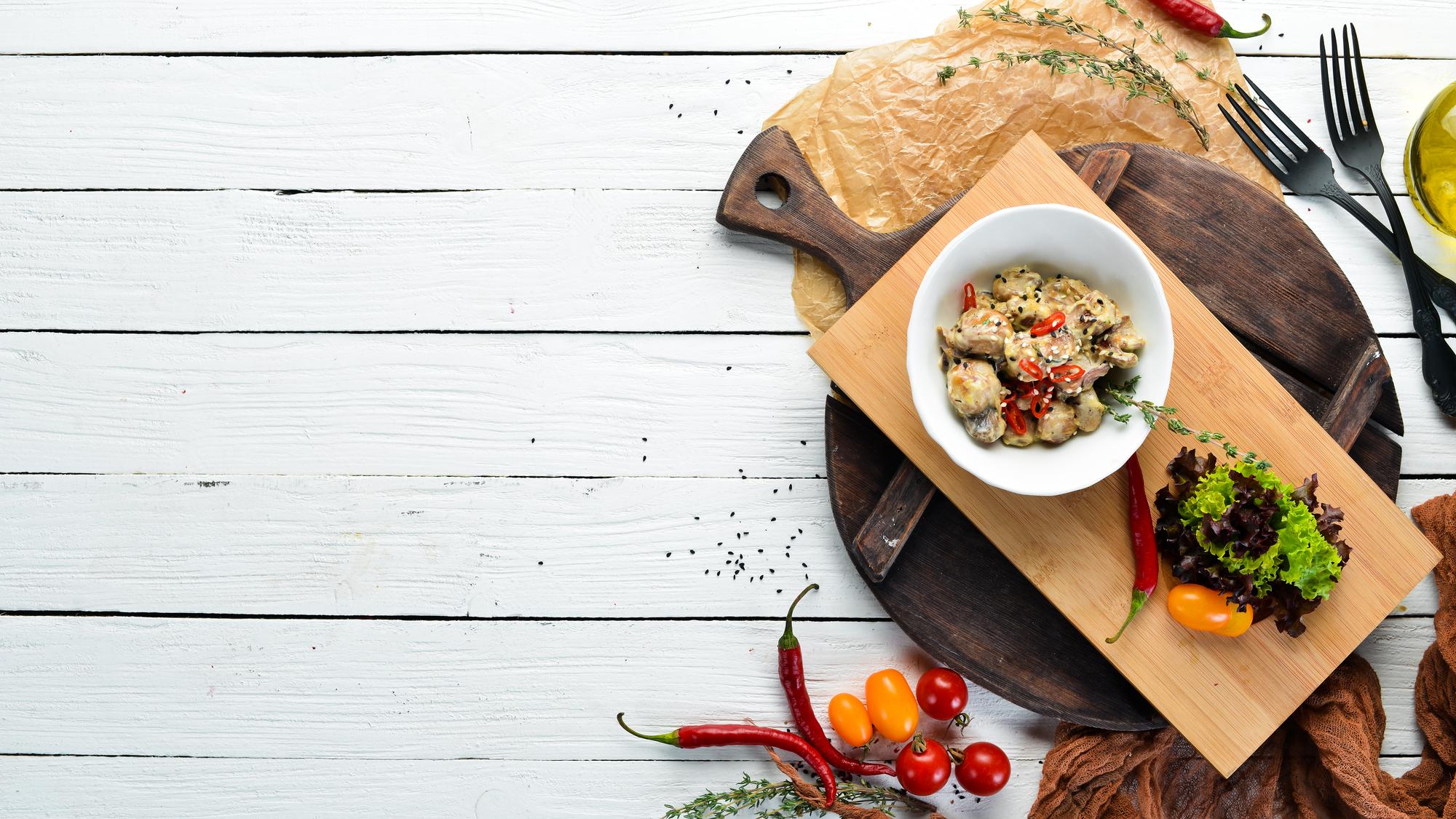 Wide shot of rustic kitchen table with prepared dishes